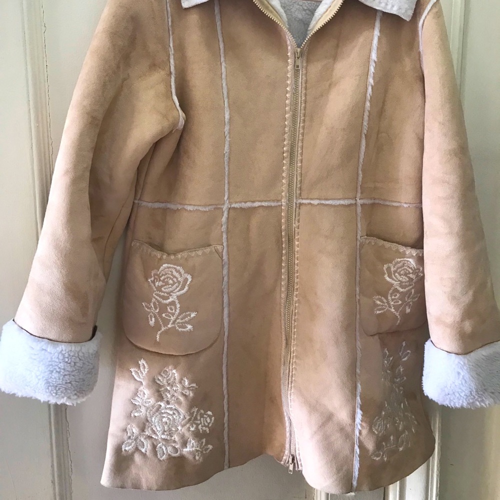 Tan colored coat with floral embellishments